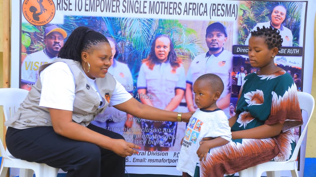 Director Ruth Katusabe with single mother and child in Fort Portal